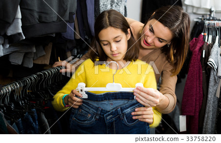 Mother and daughter deciding on new jeans Mother and daughter deciding on new jeans 33758220
