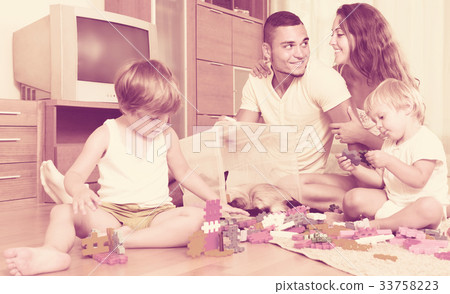 Family of four at home with toys 33758223