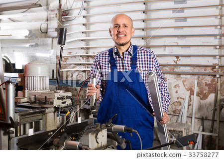 Professional worker in PVC shop. Professional worker in PVC shop. 33758277