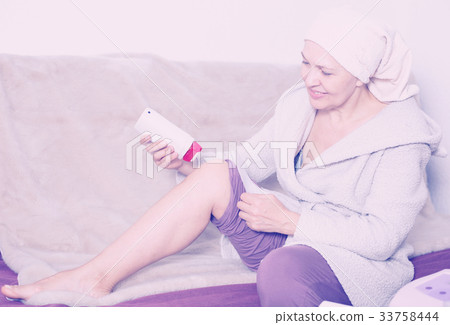 Woman doing body hair removal Woman doing body hair removal 33758444