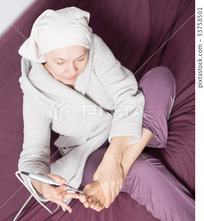 Woman doing pedicure Woman doing pedicure 33758501
