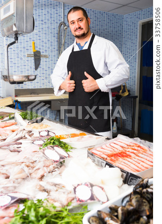 Seller showing fish lying Seller showing fish lying 33758506