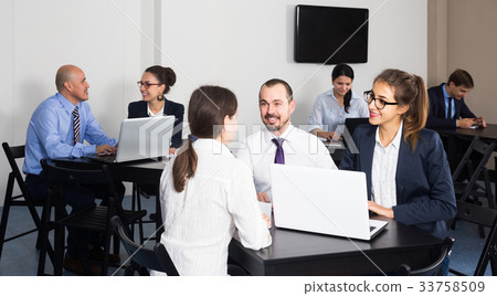 People working productively on business project together 33758509