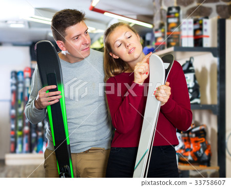 Family in sport equioment are choosing modern ski Family in sport equioment are choosing modern ski 33758607