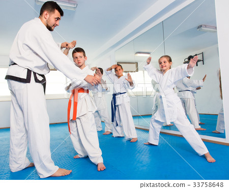 Trainer is correcting children moves Trainer is correcting children moves 33758648