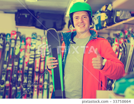 Portrait of client man in helmet and jacket who is standing with Portrait of client man in helmet and jacket who is standing with 33758664