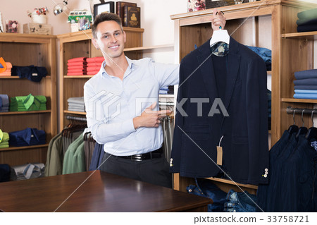 Seller demonstrating cloths 33758721