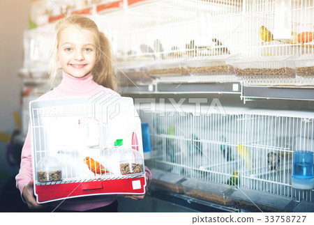Girl enjoying her purchase of canary bird 33758727