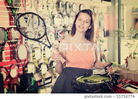 Smiling young woman with racket for tennis 33758774