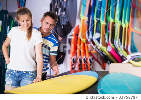 Couple choosing surfboard Couple choosing surfboard 33758787