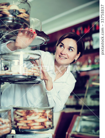Woman choosing dessert Woman choosing dessert 33758837