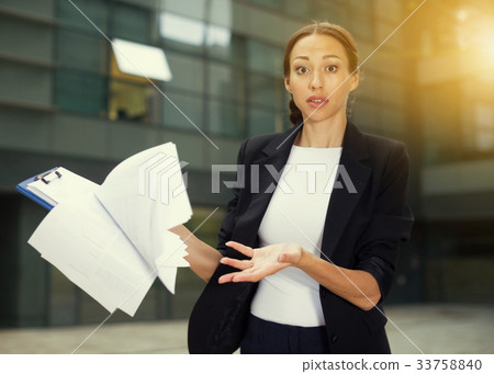 Serious female employee is dissatisfied of the results of the fi Serious female employee is dissatisfied of the results of the fi 33758840
