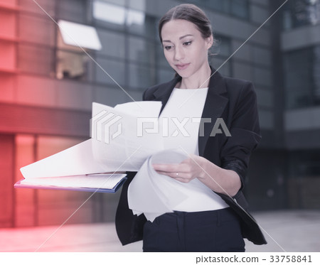 Female creative director is examining documents Female creative director is examining documents 33758841