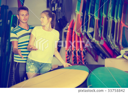 Joyful couple is choosing colorful boards Joyful couple is choosing colorful boards 33758842