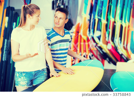 Couple choosing surfboard Couple choosing surfboard 33758843