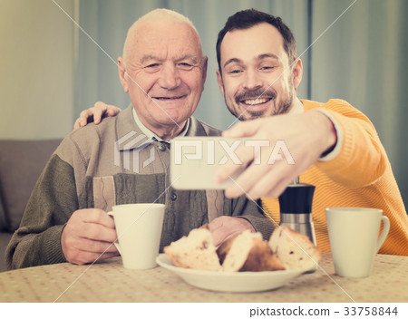 Father and son taking photos 33758844