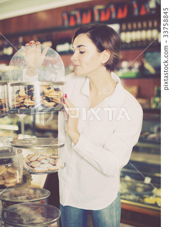 Woman choosing dessert Woman choosing dessert 33758845