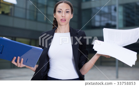 Serious woman is dissatisfied of the results of the financial report Serious woman is dissatisfied of the results of the financial report 33758853