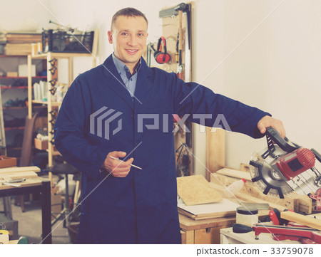 Woodworker posing in workshop Woodworker posing in workshop 33759078