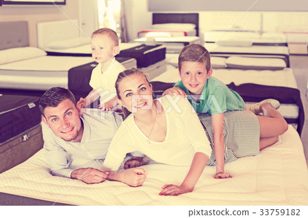 Family choosing mattress in store Family choosing mattress in store 33759182