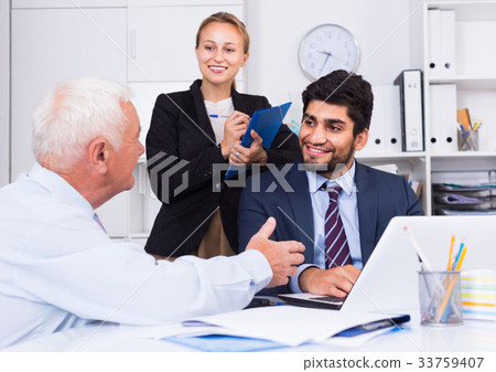 Mature man is talking to colleague 33759407