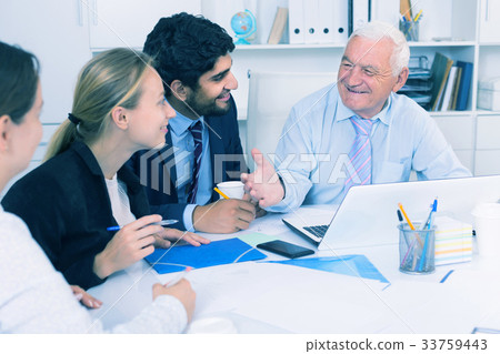 Colleagues are working together at computer 33759443