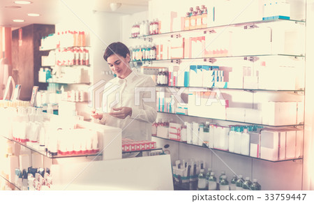 Woman is browsing rows of body care products 33759447