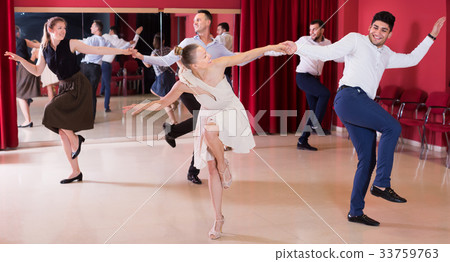 Smiling group people dancing lindy hop in pairs 33759763