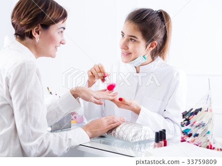 Woman doing manicure 33759809