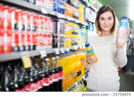 Happy woman choosing refreshing beverages 33759974
