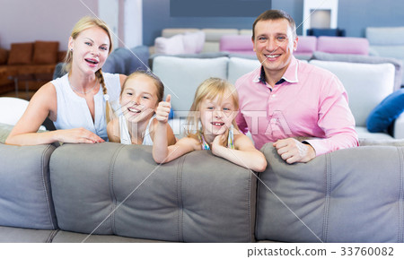 Family are choosing new sofa in furniture store. Family are choosing new sofa in furniture store. 33760082