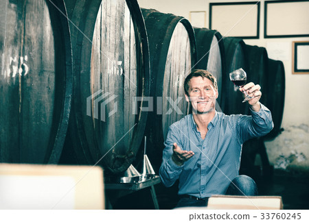 Man wine maker holding wineglass for tasting 33760245