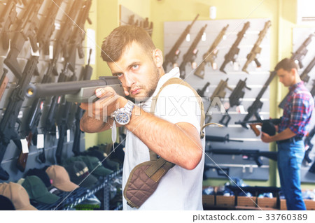 Men choosing air weapon Men choosing air weapon 33760389