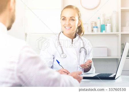 Smiling woman doctor consulting client 33760530