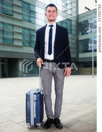 Successful adult businessman in suit with suitcase is staying 33760788
