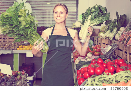 Seller holding fresh celery and mangold Seller holding fresh celery and mangold 33760908
