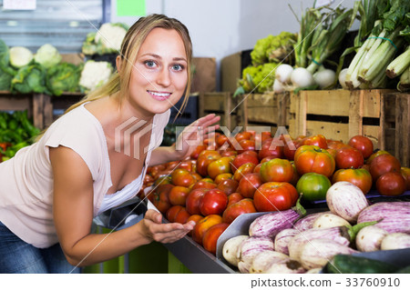 Customer choosing fresh ripe tomatoes Customer choosing fresh ripe tomatoes 33760910
