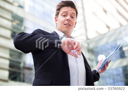 Man in jacket with documents hurrying to meeting Man in jacket with documents hurrying to meeting 33760922