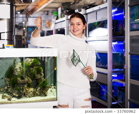 Girl keeps aquarian fish net and water container Girl keeps aquarian fish net and water container 33760962