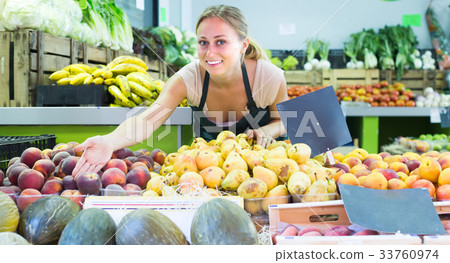 young woman selling fruits at market . young woman selling fruits at market . 33760974