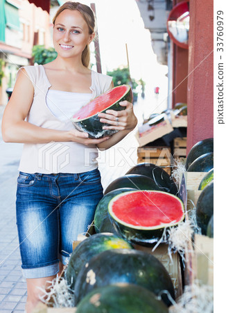 Customer choosing big ripe watermelon 33760979