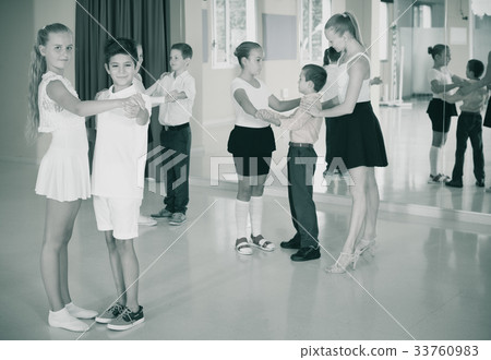 Group of children dancing tango in dance studio Group of children dancing tango in dance studio 33760983