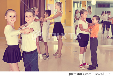 Little boys and girls having dancing class in classroom Little boys and girls having dancing class in classroom 33761002
