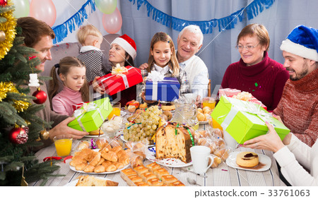 Family exchanging Christmas gifts 33761063