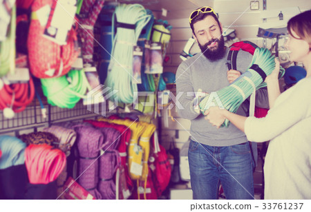 Couple deciding on climbing equipment 33761237