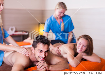 Couple is relaxing while taking massage Couple is relaxing while taking massage 33761461