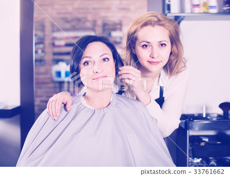 Woman is satisfied with work of haircutter 33761662