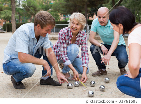 friendly mature couples playing petanque at leisure friendly mature couples playing petanque at leisure 33761695