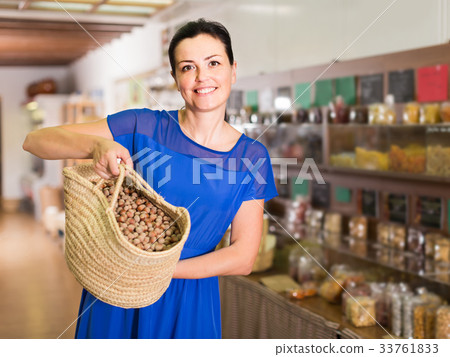 woman displayed big shopping bag with nuts in eco market woman displayed big shopping bag with nuts in eco market 33761833