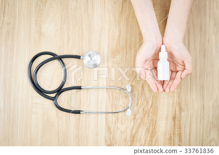 Hand holding a white medicine bottle. Hand holding a white medicine bottle. 33761836